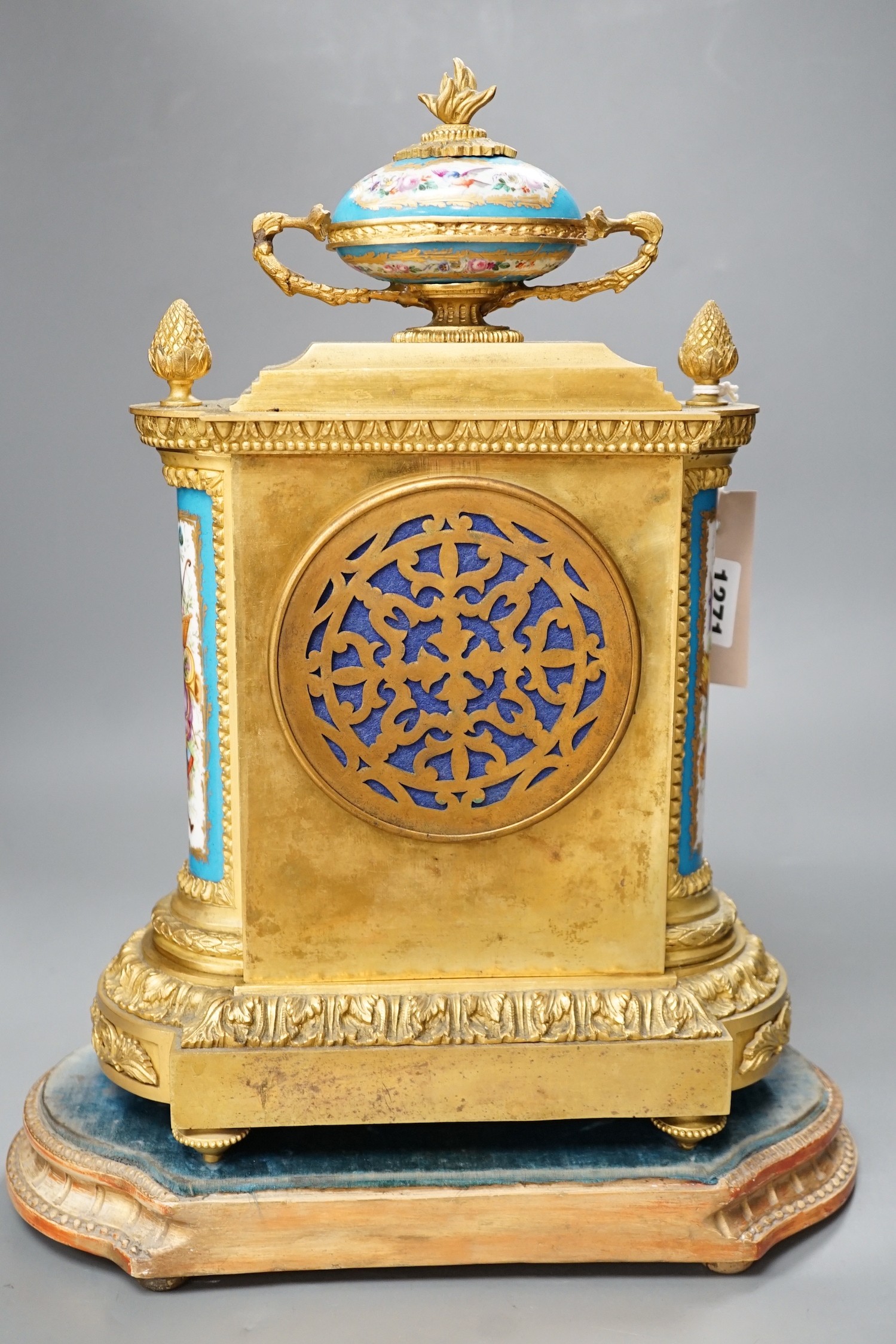 A French ormolu mantel clock, with inset floral decorated porcelain plaques and dial, 34cm high